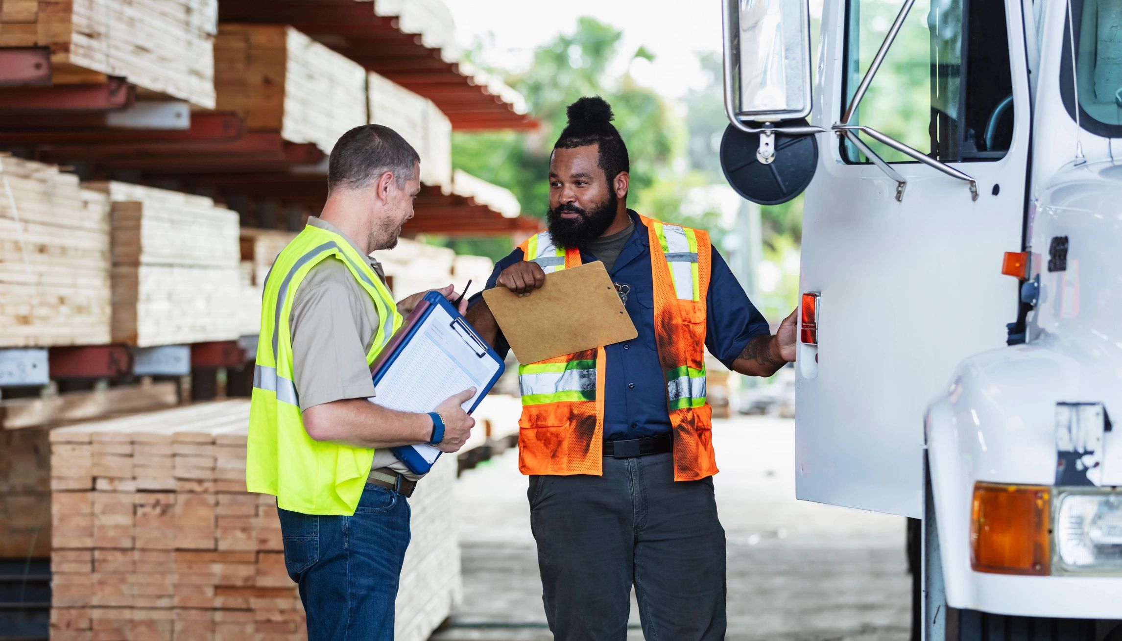 Recruiter speaking with a driver while reviewing paperwork