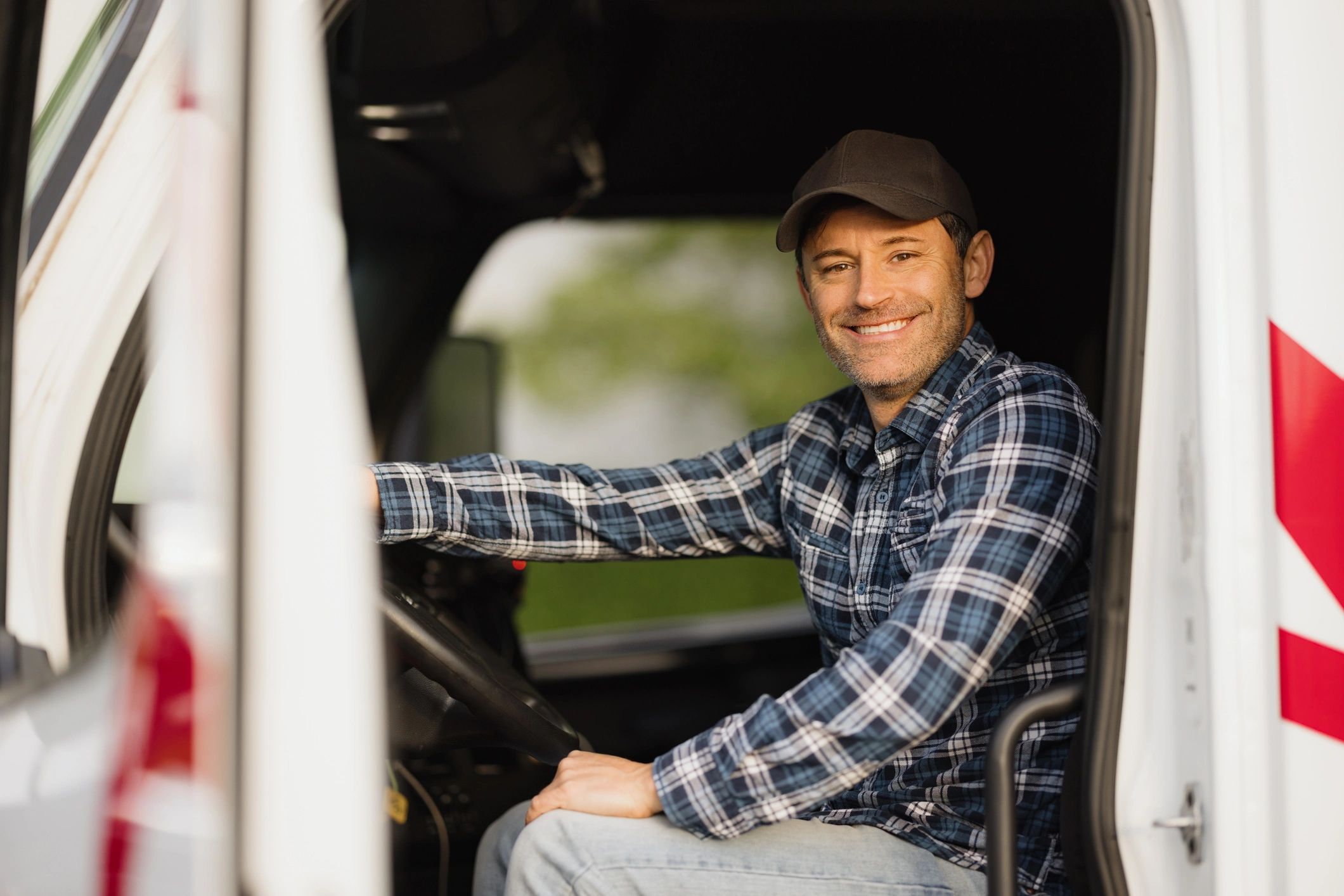 Portrait of a professional truck driver in a cab