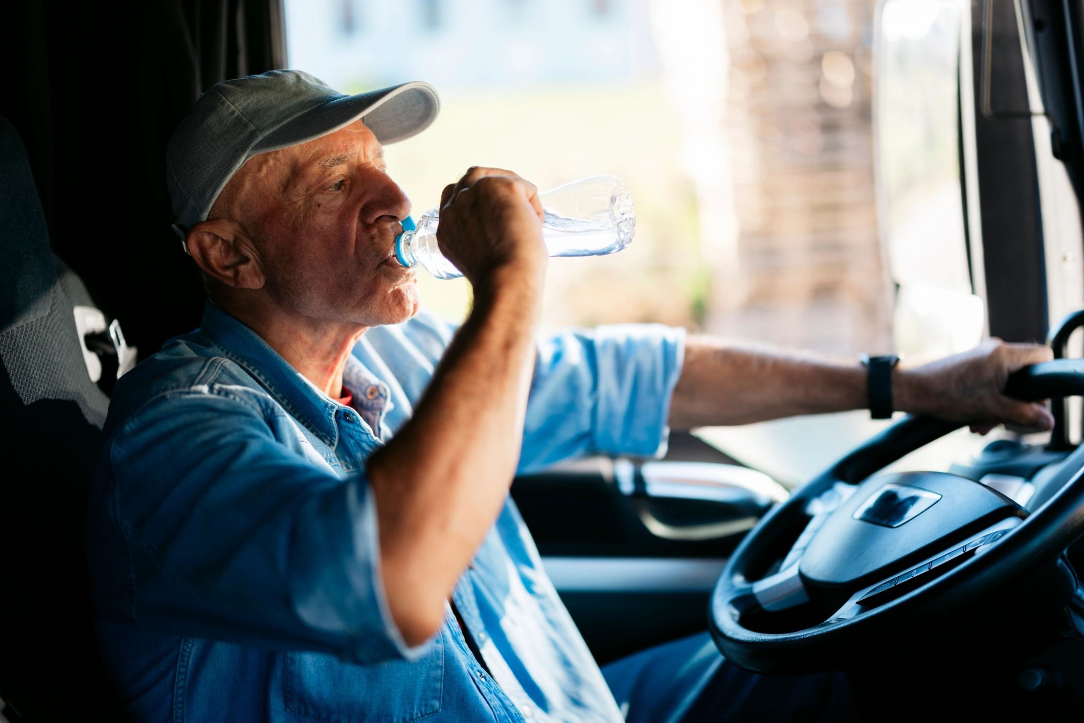 Truck driver driving on a sunny day